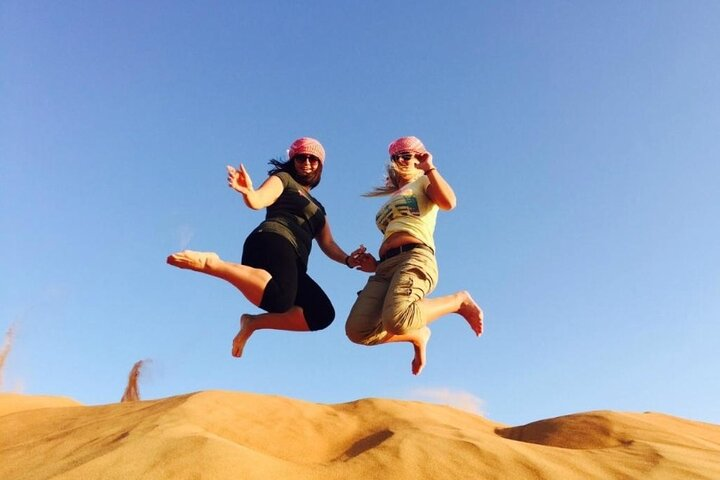 Experience the exhilaration of jumping across the stunning red dunes of Nazwa Dubai where adventure meets tradition in a stunning desert landscape. Create lasting memories in every leap!